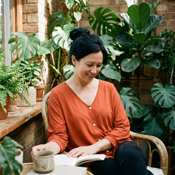 Draped V neck top in a plant filled room